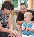 Health visitor smiling at a child